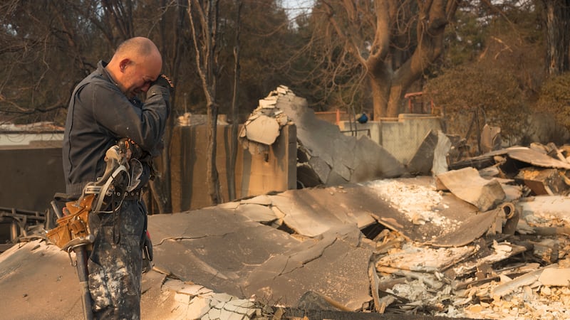 FILE - Cesar Plaza becomes emotional while looking at his home destroyed by the Eaton Fire in...