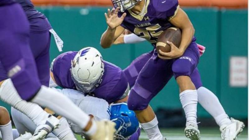Monarch running back Amo Sulu searches for running room in second half against #8 Moanalua